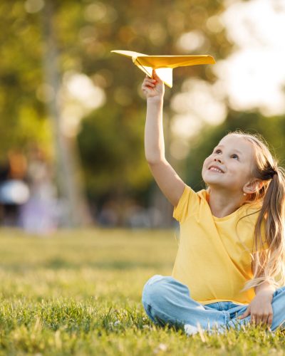 Child playing with paper plane